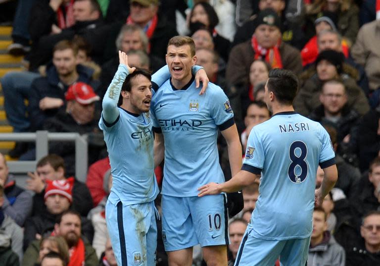 Manchester City's Edin Dzeko (C) celebrates with teammates David Silva (L) and Samir Nasri during their Premier League match against Liverpool at Anfield on March 1, 2015