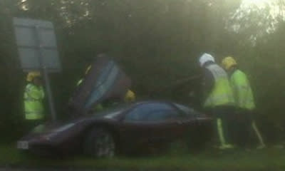 Rowan Atkinson crashes his 230mph supercar, managing to survive with minor injuries.