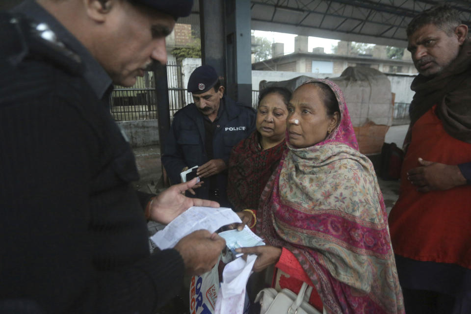 Pakistani police officers check documents of passengers travel to India via Samjhota Express at Lahore railway station in Pakistan, Thursday, Feb. 21, 2019. Indian authorities suspended a bus service this week without explanation. The development comes amid escalated tensions between Pakistan and India in the wake of last week's deadly suicide bombing in Kashmir against Indian paramilitary troops. (AP Photo/K.M. Chaudary)