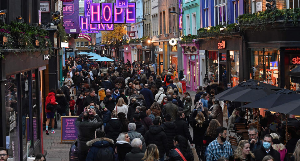 Shoppers and pedestrians are seen in Carnaby Street in London on December, as people take advantage of the easing of England's restrictions on shop openings to combat the spread of coronavirus.