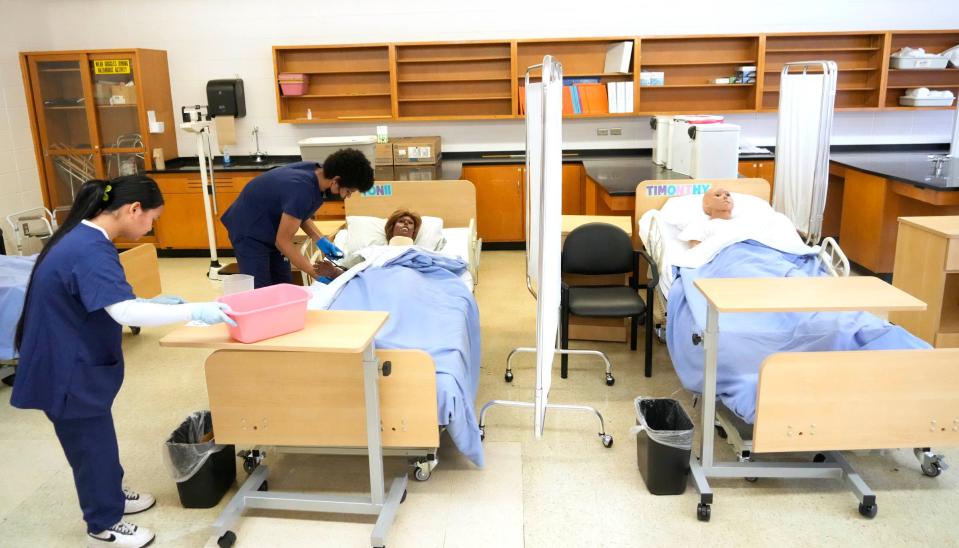 Students work in the Certified Nurse Assistant program room at James Madison High School. It's a popular program at the school.