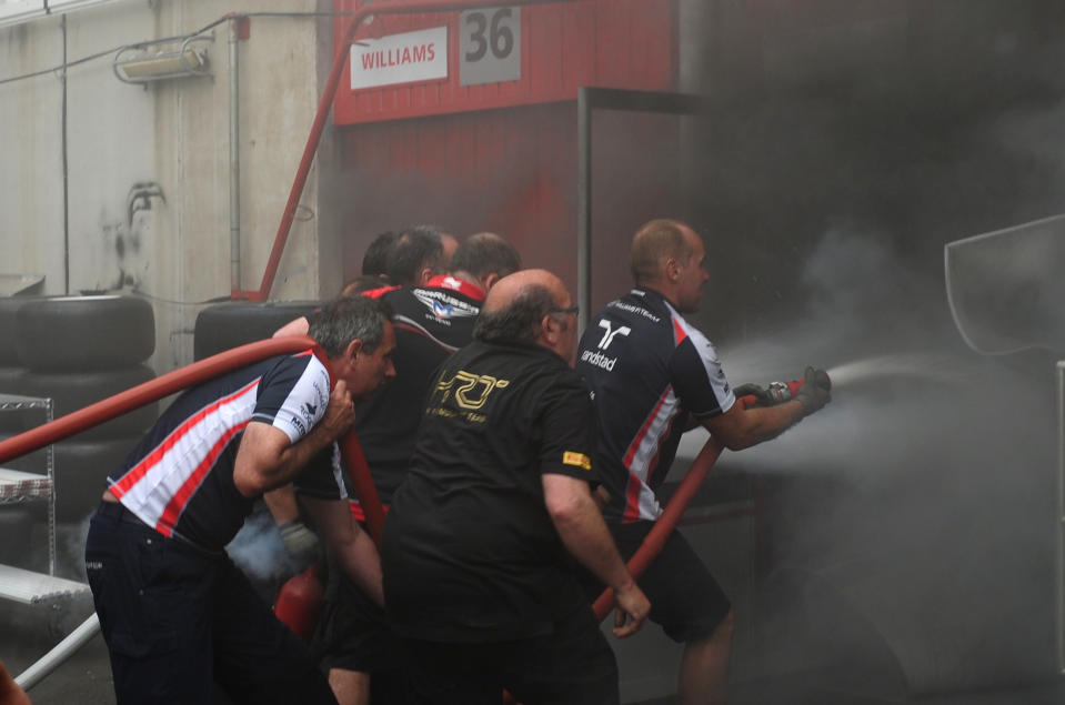 Racing team crews try to extinguish a fire in the Williams racing pit stand at the Circuit de Catalunya on May , 2012 in Montmelo on the outskirts of Barcelona after the Spanish Formula One Grand Prix.     AFP PHOTO / DIMITAR DILKOFFDIMITAR DILKOFF/AFP/GettyImages