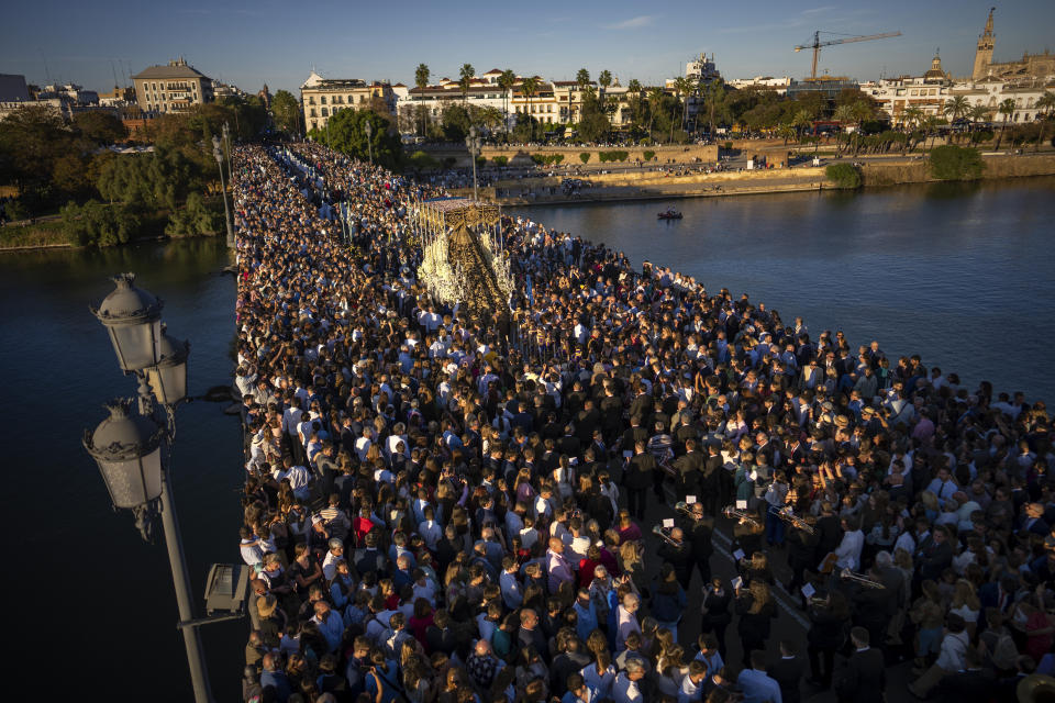 A portable dais platform which supports a statue of the Virgin Mary, is carried by "costaleros" during a procession in Seville, Spain, Sunday, April 2, 2023. Hundreds of processions take place throughout Spain during the Easter Holy Week. (AP Photo/Emilio Morenatti)