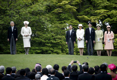 FILE PHOTO : Japan's Emperor Akihito (L), flanked by Empress Michiko (2nd L), makes an appearance before guests with his royal family members Crown Prince Naruhito (5th R), Crown Princess Masako (4th R), Prince Akishino (3rd R), Princess Kiko (2nd R) and their daughter Princess Mako during the annual spring garden party at the Akasaka Palace imperial garden in Tokyo, Japan, April 27, 2016. REUTERS/Issei Kato/File Photo