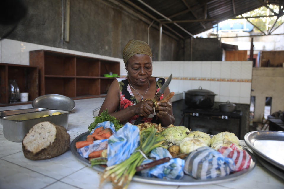 Rose Felicien 62, known as Tiwoz prepare ingredients to make soup joumou, at a restaurant in the Delmas district of Port-au-Prince, Haiti, Sunday, Feb. 5, 2023. Made of pumpkin, beef, carrots, cabbage, ingredients produced on the island, soup joumou is a cultural staple in Haiti. (AP Photo/Odelyn Joseph)