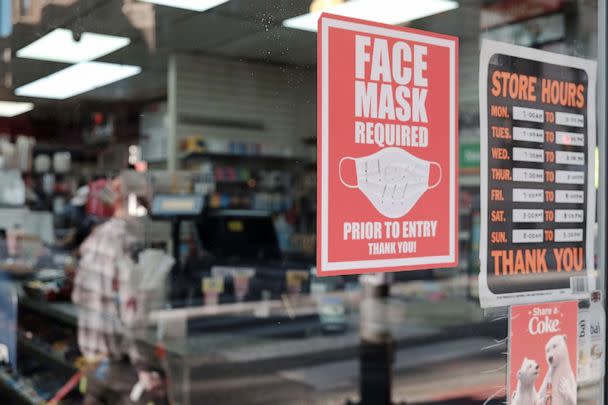 PHOTO: A sign on a store entrance asks people to wear masks, April 15, 2022, in Philadelphia. (Spencer Platt/Getty Images, FILE)