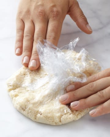 <div class="caption-credit"> Photo by: Martha Stewart Living</div><div class="caption-title">Press the Dough This Way to Form It into a Rough Round</div><b>Press the Dough This Way to Form It into a Rough Round</b> <br> Bring the edges of the plastic wrap together to form a round mass, and press on top of the wrap to form a disk. You're simultaneously gathering the crumbs into a cohesive dough and shaping it.