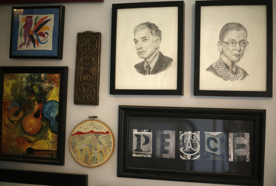 Drawings of political activist Ralph Nader and U.S. Supreme Court Justice Ruth Bader Ginsburg hang on a wall of Alison Dreith's home in southern Illinois on Wednesday, April 13, 2022. Dreith, who works from home, is employed by the Midwest Access Coalition, which pays for "practical support" for women seeking abortions. That includes things like air fare, gas money, hotel rooms or child care. (AP Photo/Martha Irvine)