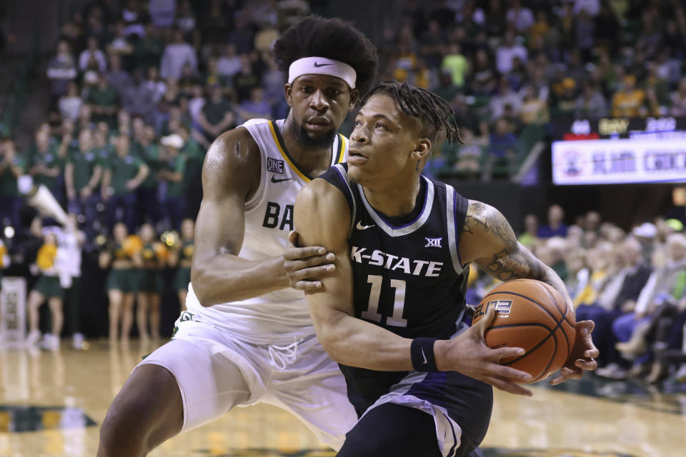 Kansas State forward Keyontae Johnson (11) drives to the basket against Baylor forward Flo Thamba, left, in the first half of an NCAA college basketball game, Saturday, Jan. 7, 2023, in Waco, Texas. (AP Photo/Rod Aydelotte)