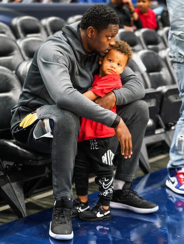 <p>Cassy Athena/Getty</p> Julius Randle of the New Orleans Pelicans plays with his son before a game against the Atlanta Hawks in Louisiana on March 26, 2019.