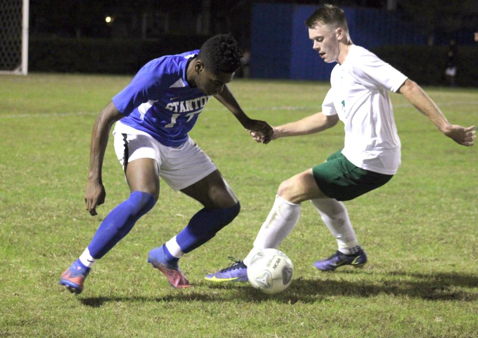 Stanton's Abdul Mujib Musa (17) and Fleming Island's William Kennedy (14) challenge for possession during a high school boys soccer game on Nov. 29.