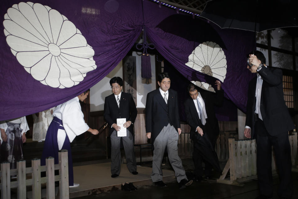 FILE - Then Japan's main opposition Liberal Democratic Party President Shinzo Abe, center, leaves the Yasukuni Shrine after he paid homage to the war dead in Tokyo after he became the party leader on Oct. 17, 2012. Former Japanese Prime Minister Abe, a divisive arch-conservative and one of his nation's most powerful and influential figures, has died after being shot during a campaign speech Friday, July 8, 2022, in western Japan, hospital officials said. (AP Photo/Shizuo Kambayashi, File)