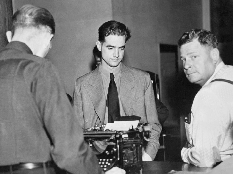 Howard Hughes is shown here as he was booked on a suspicion of negligent homicide by Det. Lieut. Tom Sketchley, following a traffic accident in which Gabe S. Meyer,a pedestrian, was allegedly struck and killed by Hughes' automobile.