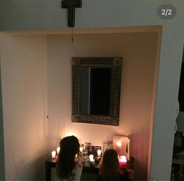 Carli Pierson's daughters pray at the Day of the Dead altar in November 2020.