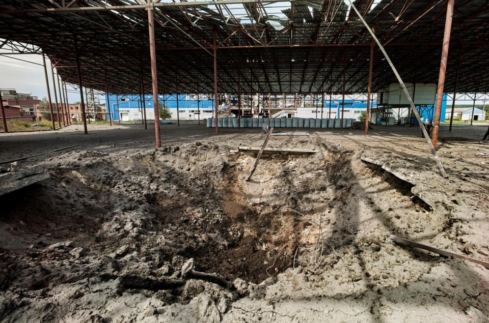 A shelling hole at a factory building damaged in a rocket hit in the small city of Merefa of Kharkiv area (EPA)