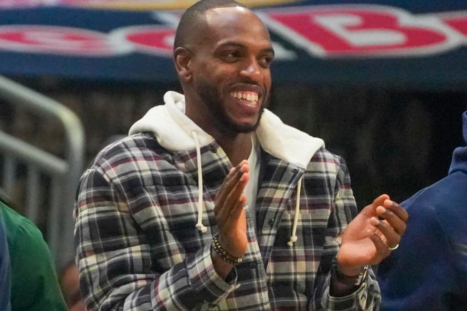 Milwaukee Bucks forward Khris Middleton applauds his teammates during the second half against the Utah Jazz on Saturday at Fiserv Forum. Middleton missed the game with knee soreness.