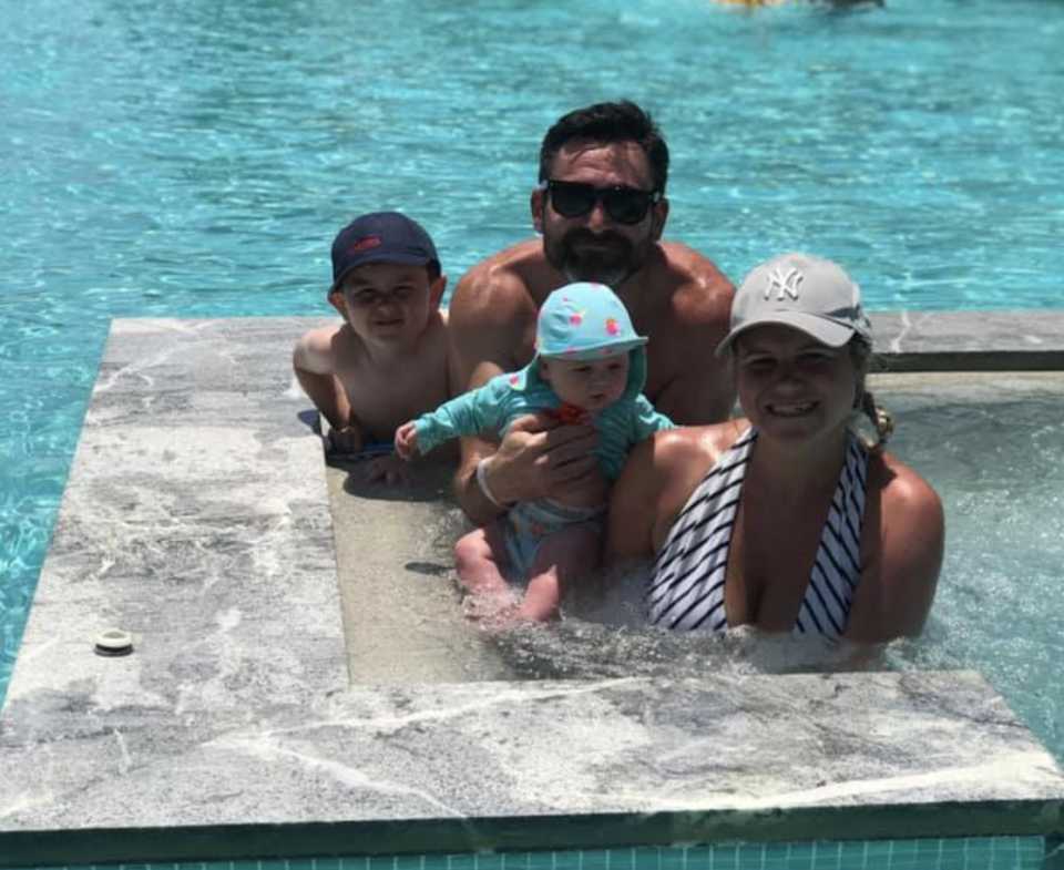 Katherine McAuley pictured with her young family in Greece in a swimming pool. 