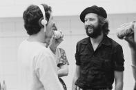 <p>Eric Clapton speaks with his support staff while on tour in the United States in 1975. </p>