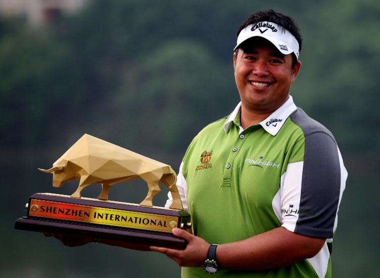 Kiradech Aphibarnrat of Thailand poses with his trophy after winning the Shenzhen International golf tournament on April 19, 2015