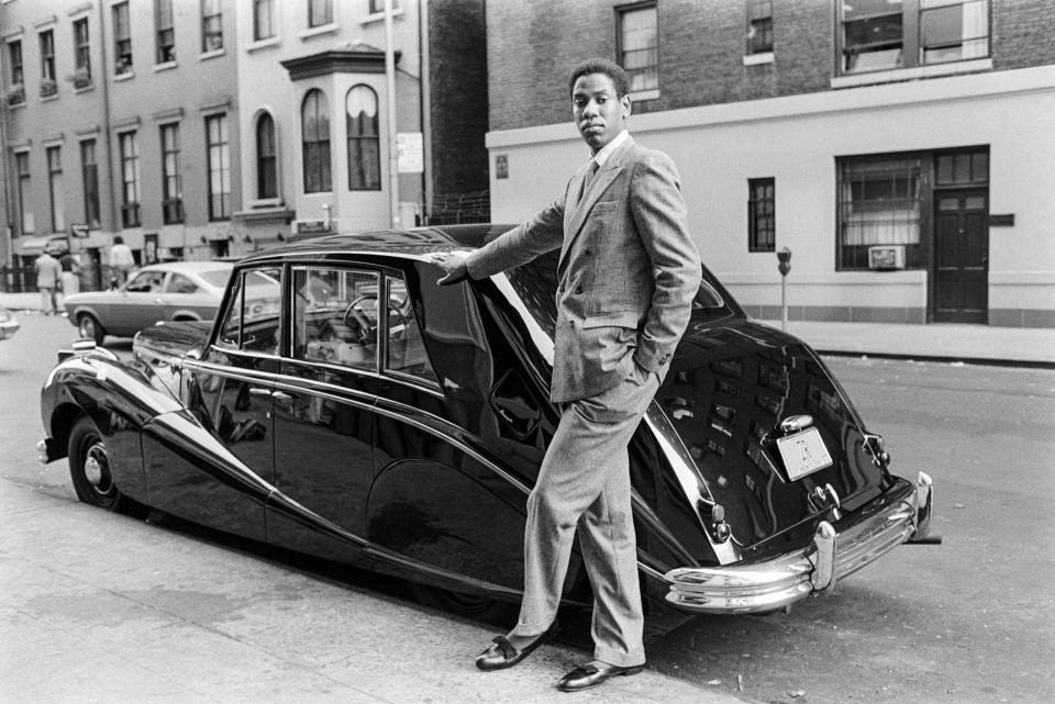 Andre Leon Talley poses in front of a luxury car in New York, 1979.