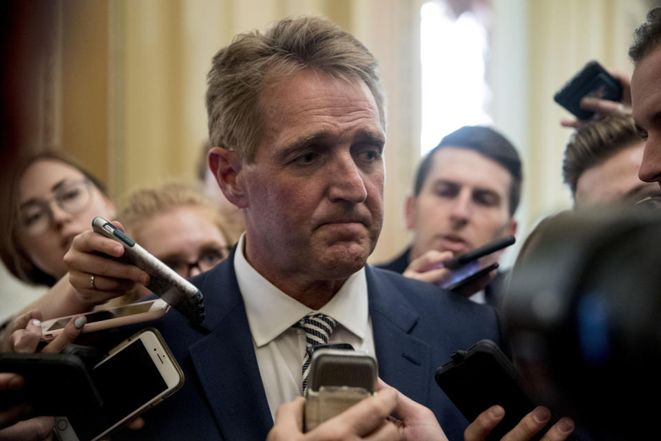 Sen. Jeff Flake, R-Ariz., listens to a question from a reporter after meeting with Senate Majority Leader Mitch McConnell of Ky. in his office in the Capitol in Washington, Friday, Sept. 28, 2018. The Senate Judiciary Committee advanced Brett Kavanaugh's nomination for the Supreme Court after agreeing to a late call from Sen. Jeff Flake, R-Ariz., for a one week investigation into sexual assault allegations against the high court nominee. (AP Photo/Andrew Harnik)