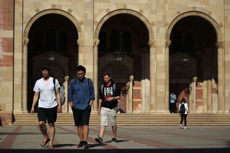 People walk in front of Royce Hall on the University of California Los Angeles (UCLA) campus in Los Angeles