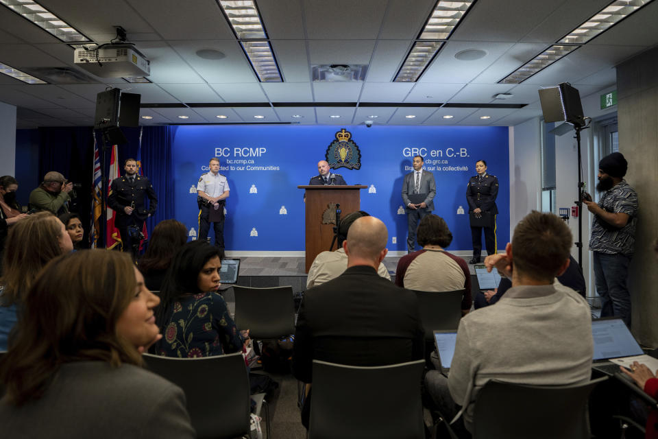 Media ask questions to Assistant Commissioner David Teboul, centre, Commander of the Federal Policing Program in the Pacific Region, along with Assistant Commissioner Brian Edwards, left, Officer-in-Charge of Surrey RCMP Detachment, and Superintendent Mandeep Mooker, second from the right, Officer-in-Charge of IHIT during a news conference for an update on the Hardeep Singh Nijjar homicide investigation from June 18, 2023, in Surrey, B.C., Friday, May 3, 2024. (Ethan Cairns/The Canadian Press via AP)