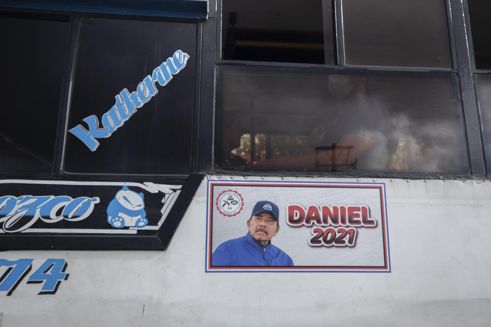 A poster promotes presidential candiate and current President Daniel Ortega on the side of a bus, in Managua, Nicaragua, Thursday, June 17, 2021. In recent weeks, Nicaragua President Daniel Ortega's government has rounded up 13 opposition leaders, including four presidential challengers for the Nov. 7 elections. They face allegations ranging from money laundering to crimes against the state. (AP Photo/Miguel Andres)