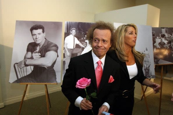 2011: Fitness gurus Richard Simmons and Denise Austin are seen near pictures of the first television fitness guru, Jack LaLanne, before the start of LaLanne's funeral service on February 1, 2011, in Los Angeles.