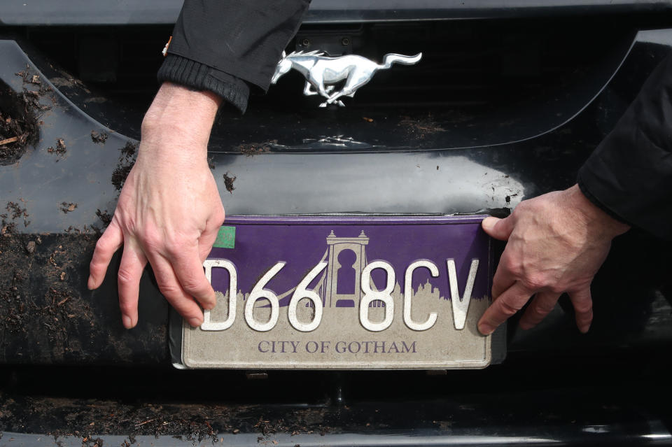 A City of Gotham number plate is fitted on a car during filming in Glasgow for a new movie for the Batman superhero franchise. (Photo by Andrew Milligan/PA Images via Getty Images)