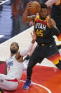 Los Angeles Clippers guard Paul George (13) reaches for the ball as Utah Jazz guard Donovan Mitchell (45) pulls down a rebound during the first half of Game 2 of a second-round NBA basketball playoff series Thursday, June 10, 2021, in Salt Lake City. (AP Photo/Rick Bowmer)