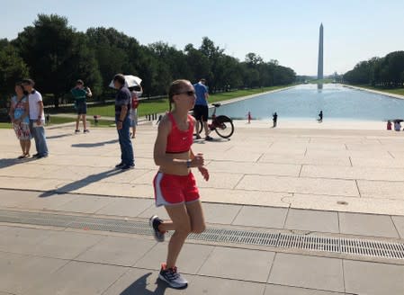 A jogger braves the heat on the plaza in front of the Lincoln Memorial, on a day when the temperature was forecast to reach 99 degrees F, in Washington