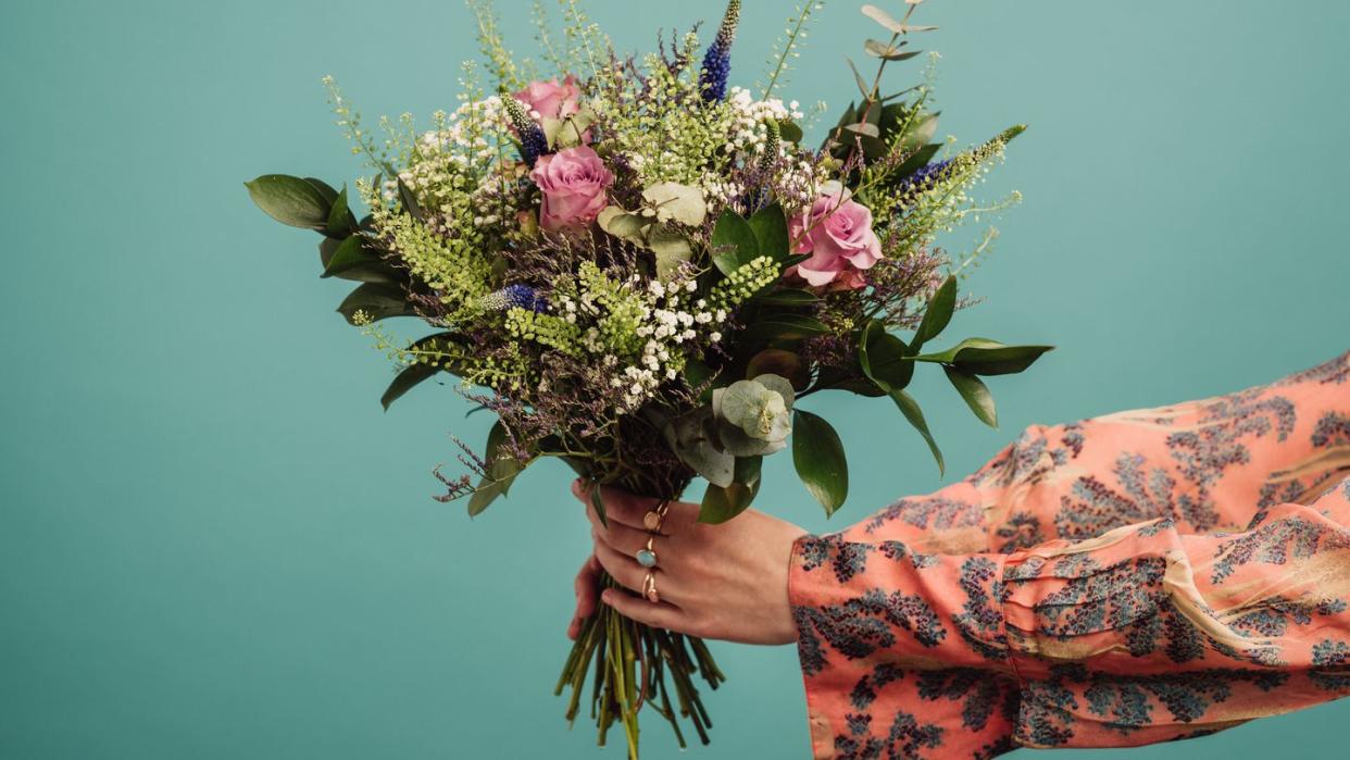 woman holding a big bouquet of flowers