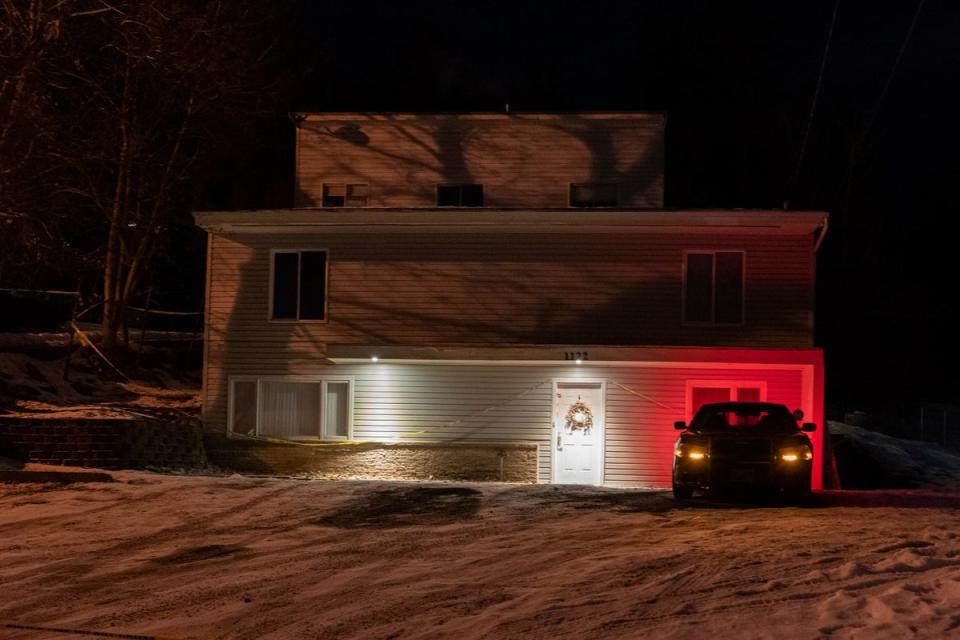 A private security officer sits in a vehicle in front of the house in Moscow where the students were killed (Copyright 2023 The Associated Press. All rights reserved.)