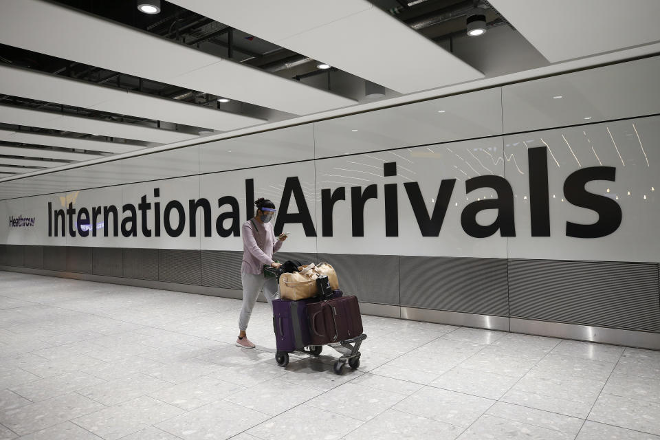 LONDON, ENGLAND - JANUARY 30: Travelers arrive at Heathrow Terminal 5 on January 30, 2021 in London, England. The UK government has added flights from the UAE to the 