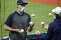 Tampa Bay Rays pitcher Blake Snell, left, juggles baseballs with a teammate during the seventh inning of Game 2 of an American League wild-card baseball series against the Toronto Blue Jays Wednesday, Sept. 30, 2020, in St. Petersburg, Fla. (AP Photo/Chris O'Meara)