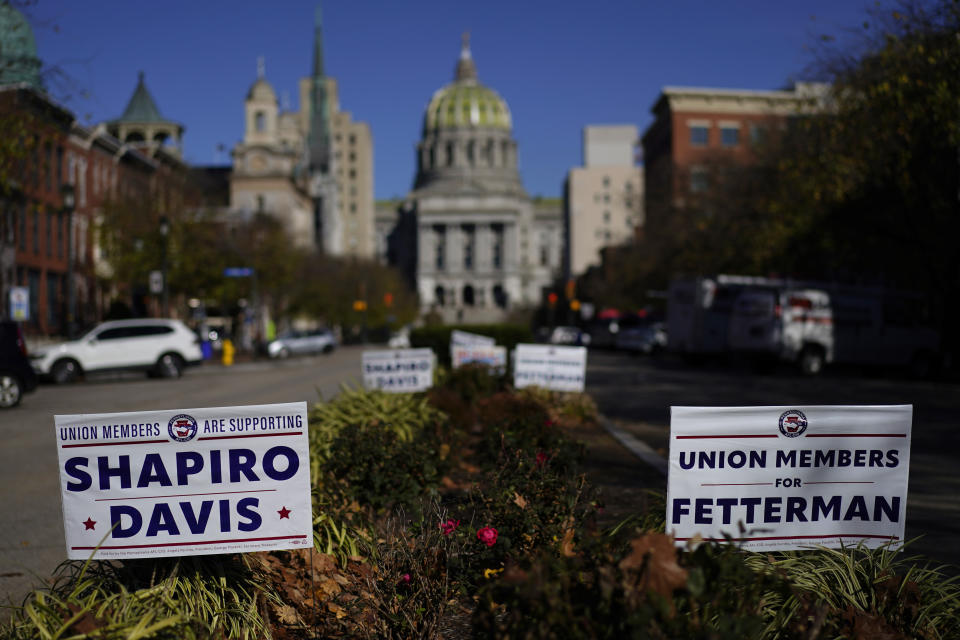 Campaign signs supporting Pennsylvania Lt. Gov. John Fetterman, Democratic candidate for U.S. Senate from Pennsylvania, and Pennsylvania gubernatorial candidate state Attorney General Josh Shapiro, are posted in front of the Pennsylvania state capitol building in Harrisburg, Pa., Tuesday, Nov. 8, 2022. (AP Photo/Carolyn Kaster)