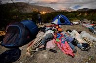 <p>Venezuelan migrants on their way to Peru sleep along the Pan-American Highway between Tulcan and Ibarra in Ecuador, after entering the country from Colombia, on August 22, 2018. – Ecuador announced on August 16 that Venezuelans entering the country would need to show passports from August 18 onwards, a document many are not carrying. And Peru followed suit on August 17, announcing an identical measure due to begin on August 25. (Photo by LUIS ROBAYO/AFP/Getty Images) </p>