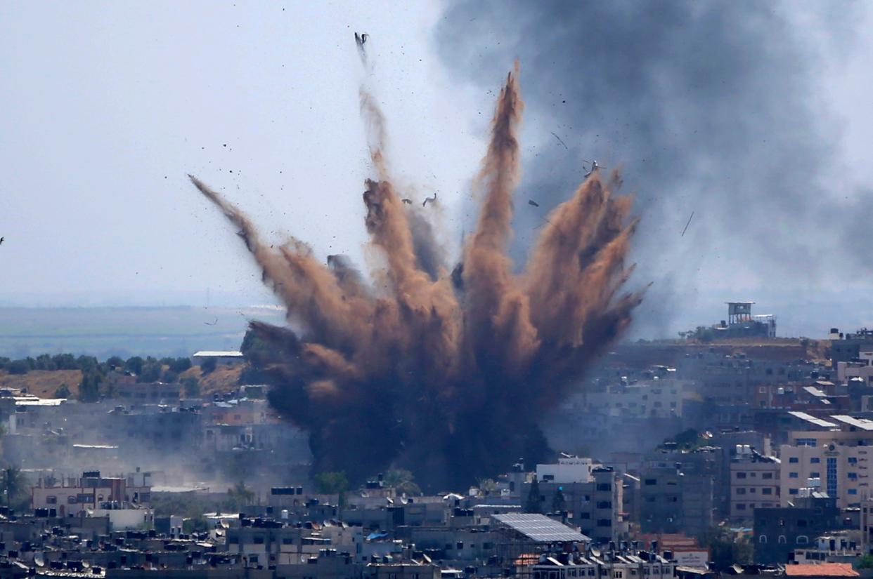 Smoke rises following Israeli airstrikes on a building in Gaza City in May (AP)