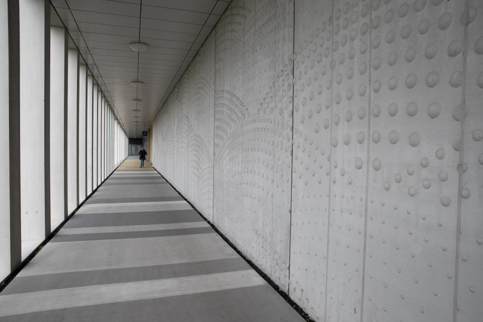 A person leaves the extra secure court building at Schiphol airport, near Amsterdam, Netherlands, Friday, March 6, 2020. A missile fired from territory controlled by pro-Russian rebels in Ukraine in 2014, tore the MH17 passenger jet apart killing all 298 people on board. United by grief across oceans and continents, families who lost loved hope that next week's trial will finally deliver them something that has remained elusive ever since: The truth. (AP Photo/Peter Dejong)