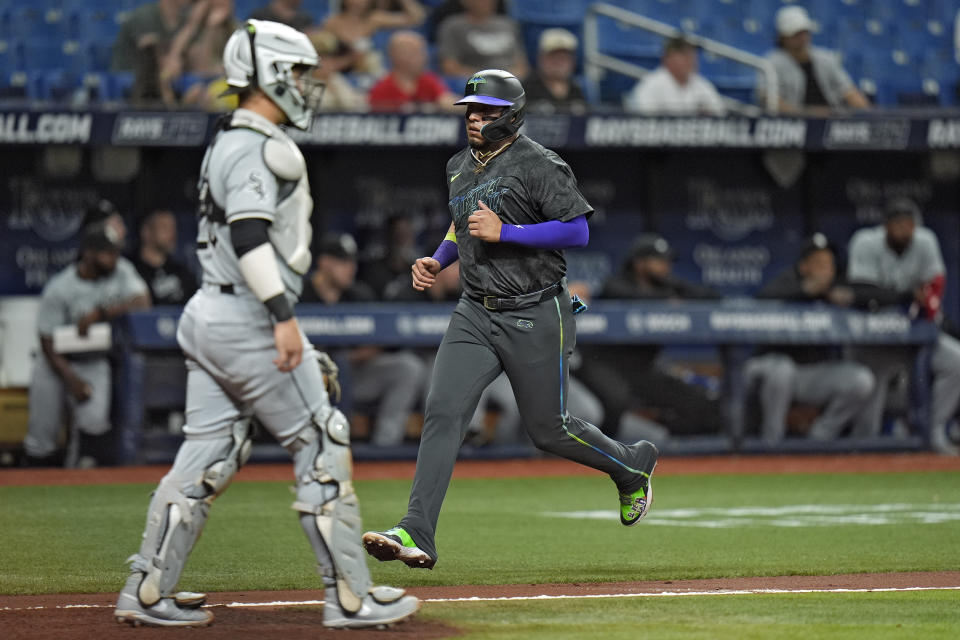 Tampa Bay Rays' Isaac Paredes scores in front of Chicago White Sox catcher Korey Lee, left, on an RBI single by Harold Ramirez during the second inning of a baseball game Tuesday, May 7, 2024, in St. Petersburg, Fla. (AP Photo/Chris O'Meara)