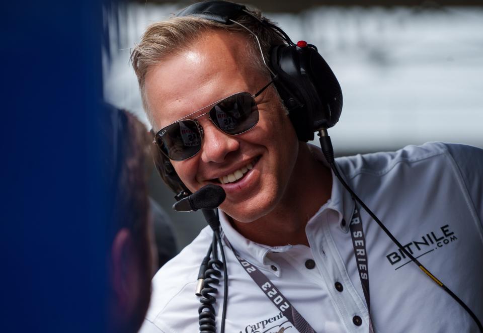 Ed Carpenter talks with a team photographer Friday, Aug. 11, 2023, during qualifications in preparation for the Gallagher Grand Prix Saturday at Indianapolis Motor Speedway. 