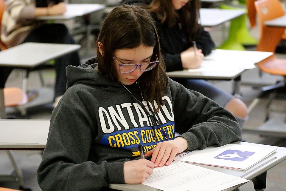 Ontario Middle School eighth grader Tatum Mottayaw works on a writing prompt during the Power of the Pen district tournament held at Ashland Middle School  Saturday, Jan. 21, 2023. TOM E. PUSKAR/ASHLAND TIMES-GAZETTE