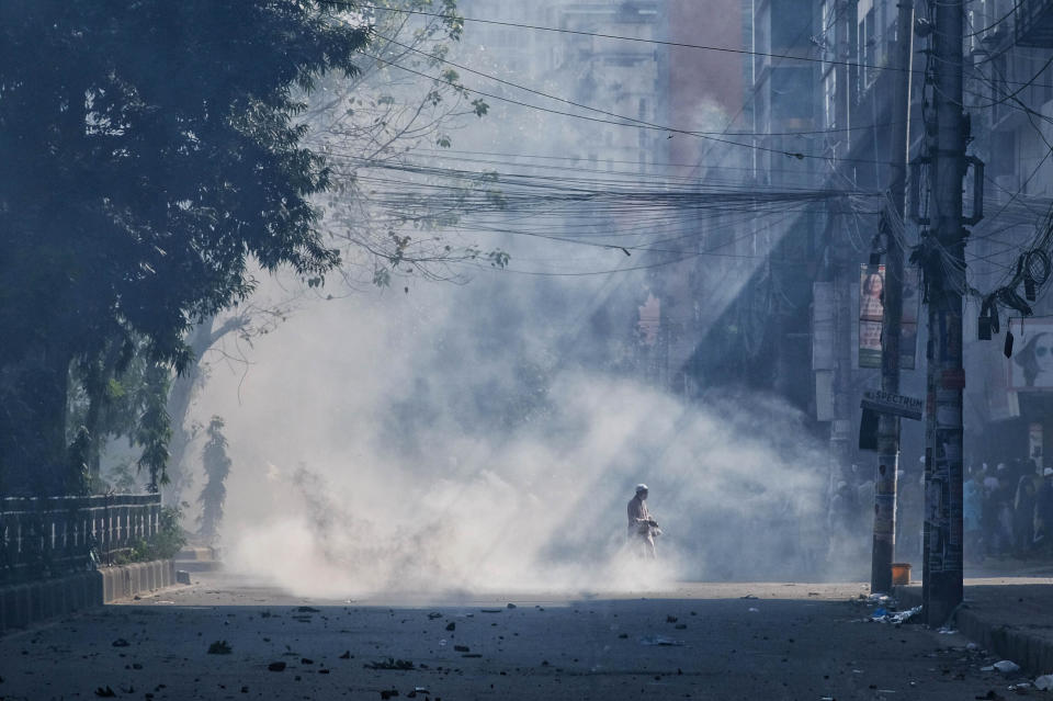 Smoke from teargas rise after police clashed with Muslim devotees during a protest over an alleged insult to Islam, outside the country’ main Baitul Mukarram Mosque in Dhaka, Bangladesh, Friday, Oct. 15, 2021. Friday’s chaos in Dhaka followed reported incidents of vandalism of Hindu temples in parts of the Muslim-majority Bangladesh after photographs of a copy of the Holy book Quran at the feet of of a Hindu Goddess went viral on social media in a temple at Cumilla district in eastern Bangladesh. (AP Photo/Mahmud Hossain Opu, File)