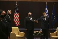 U.S. Secretary of State Mike Pompeo, left, and Greek Foreign Minister Nikos Dendias touch elbows during their meeting in the northern city of Thessaloniki, Greece, Monday, Sept. 28, 2020. Pompeo and Dendias, will sign a bilateral science and technology agreement, as well as host energy sector business leaders for a discussion to highlight energy diversification and infrastructure projects in Greece. (AP Photo/Giannis Papanikos, Pool)