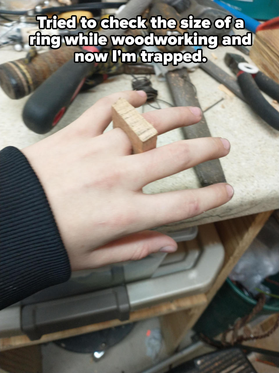 A block of wood on someone's finger