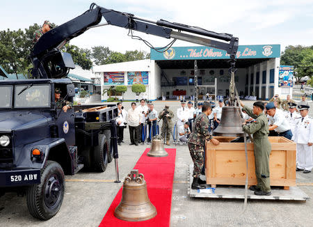 Philippine Air Force personnel unload the bells of Balangiga after their arrival at Villamor Air Base in Pasay, Metro Manila, Philippines December 11, 2018. REUTERS/Erik De Castro