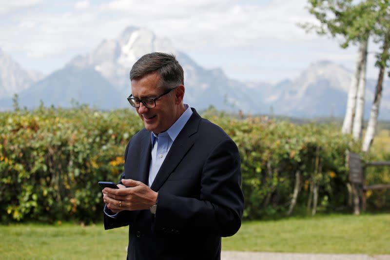 Federal Reserve Vice Chair Richard Clarida reacts as he holds his phone during the three-day "Challenges for Monetary Policy" conference in Jackson Hole