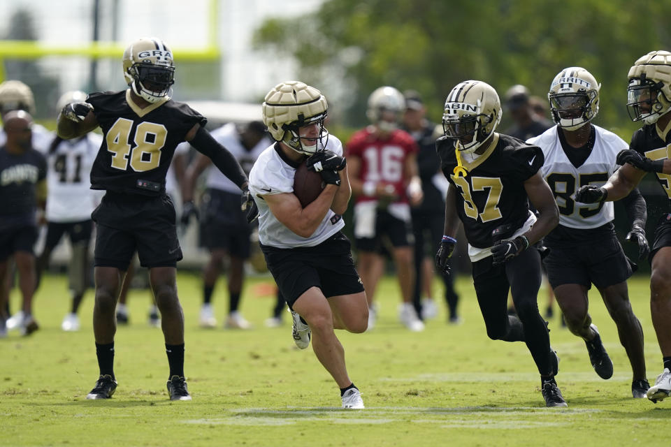 New Orleans Saints quarterback Taysom Hill carries the ball during a drill at the NFL football team's training camp in Metairie, La., Thursday, July 28, 2022. (AP Photo/Gerald Herbert)