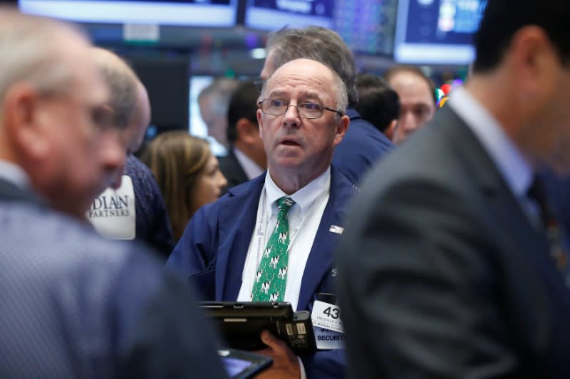 Traders work on the floor of the New York Stock Exchange (NYSE) in New York City, U.S., December 16, 2016. REUTERS/Brendan McDermid